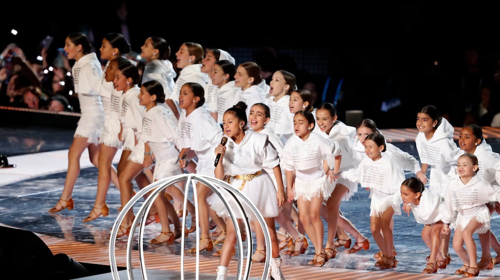 FILE - Emme Maribel Muñiz, daughter of singer Jennifer Lopez, performs with other children by a cage during the halftime show of the NFL Super Bowl 54 football game in Miami Gardens, Fla, on Feb. 2, 2020. (AP Photo/Tyler Kaufman, File)