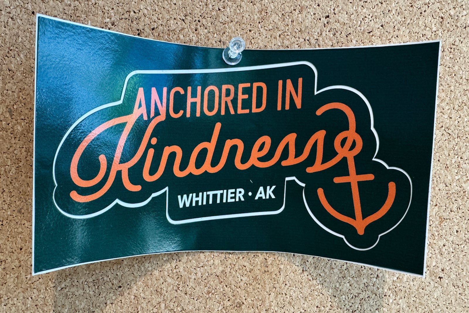 A poster with the slogan "Anchored in Kindness, Whittier, AK" is displayed in the city building in Whittier, Alaska, May 13, 2025. (AP Photo/Mark Thiessen)