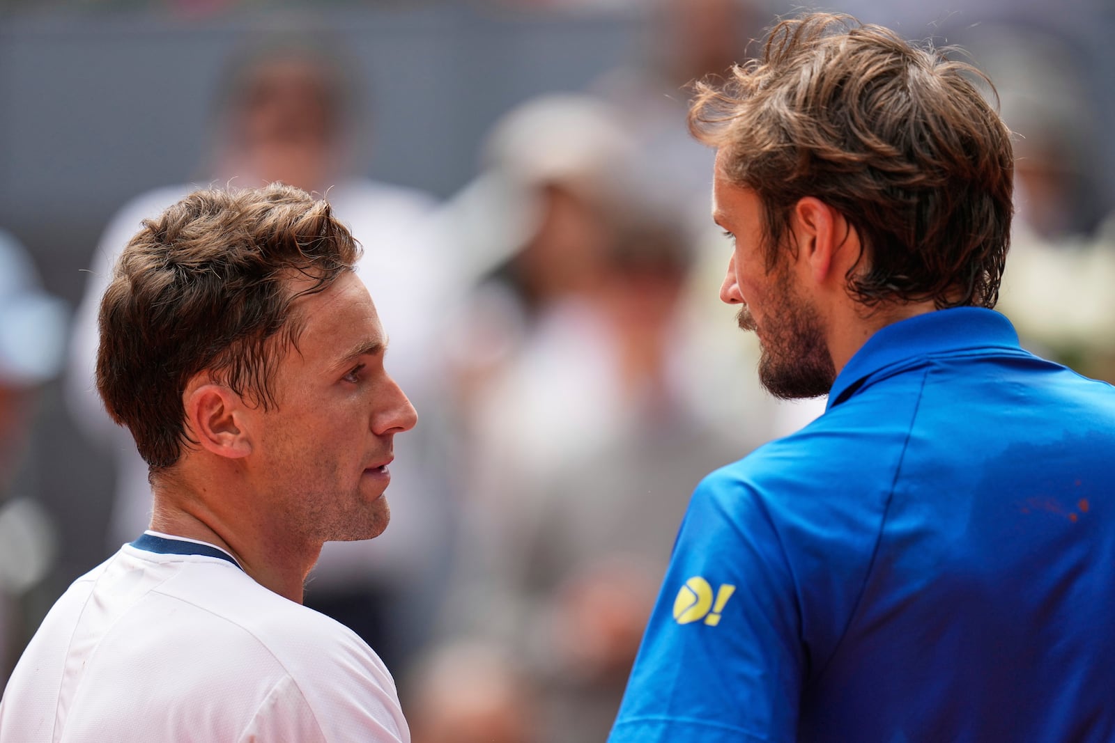 Casper Ruud of Norway, left, shakes hands after winning against Russia's Daniil Medvedev during the Madrid Open tennis tournament in Madrid, Spain, Thursday, May 1, 2025. (AP Photo/Manu Fernandez)