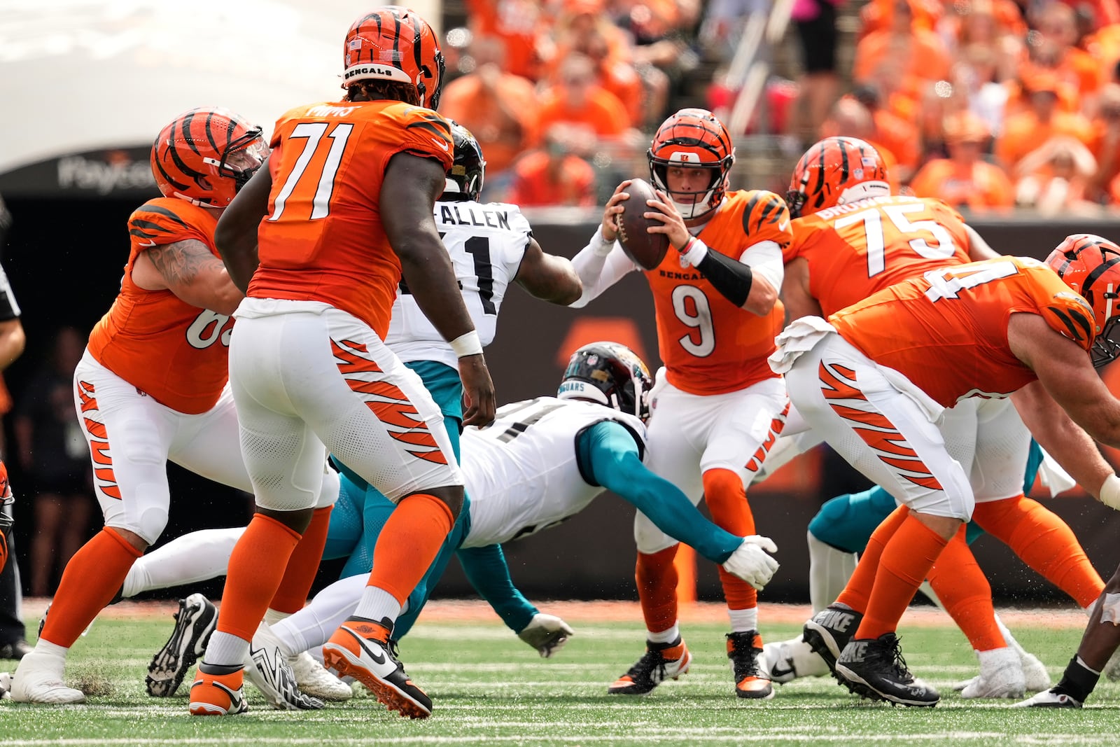 Cincinnati Bengals quarterback Joe Burrow (9) is sacked by Jacksonville Jaguars defensive tackle Arik Armstead (91) during the first half of an NFL football game, Sunday, Sept. 14, 2025, in Cincinnati. (AP Photo/Carolyn Kaster)