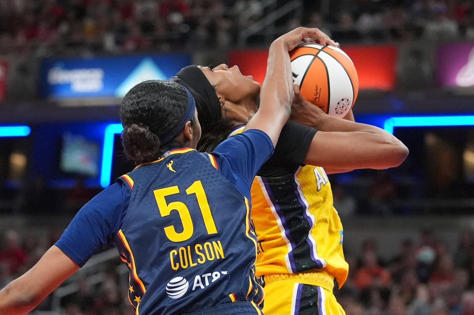 Indiana Fever's Sydney Colson (51)blocks the shot of Los Angeles Sparks' Rickea Jackson during the second half of a WNBA basketball game, Saturday, July 5, 2025, in Indianapolis. (AP Photo/Michael Conroy)