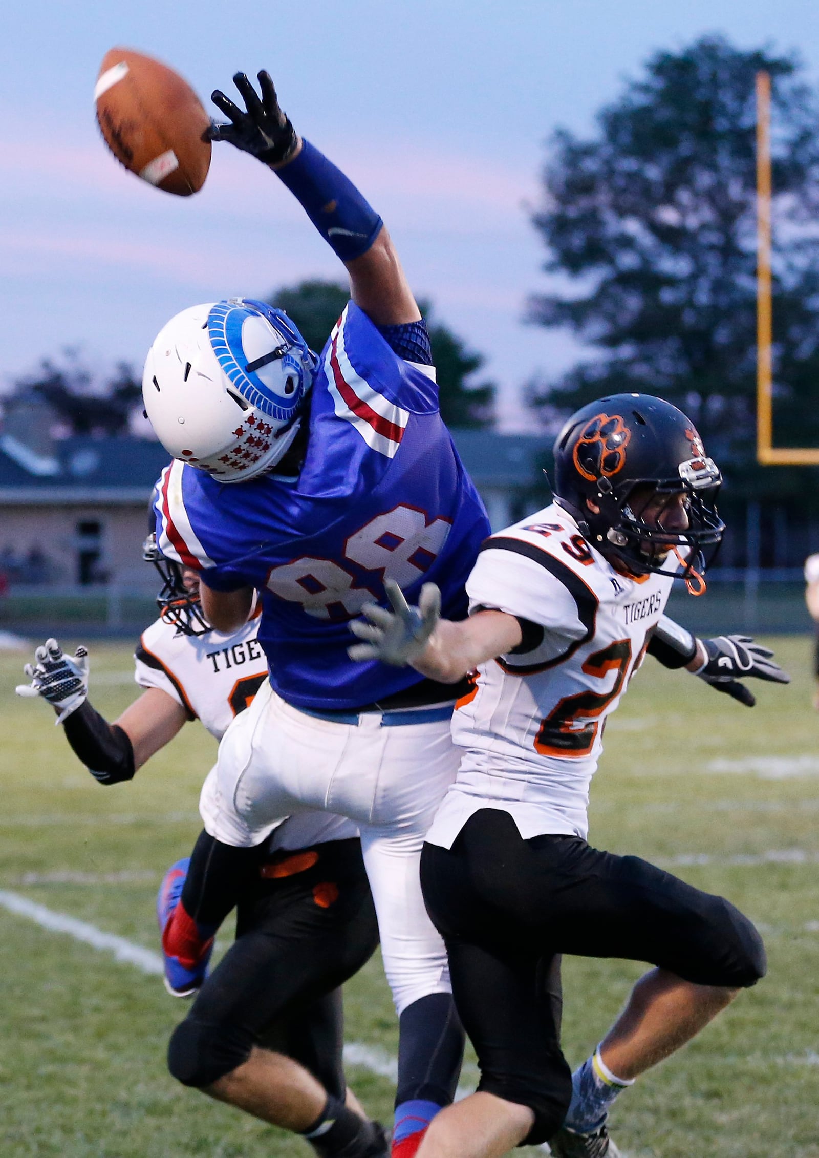 Greeveview's Ethan Bradds battles for a reception with West Liberty's Trevor Anderson, left, and Sam Strickland. Bill Lackey/Staff