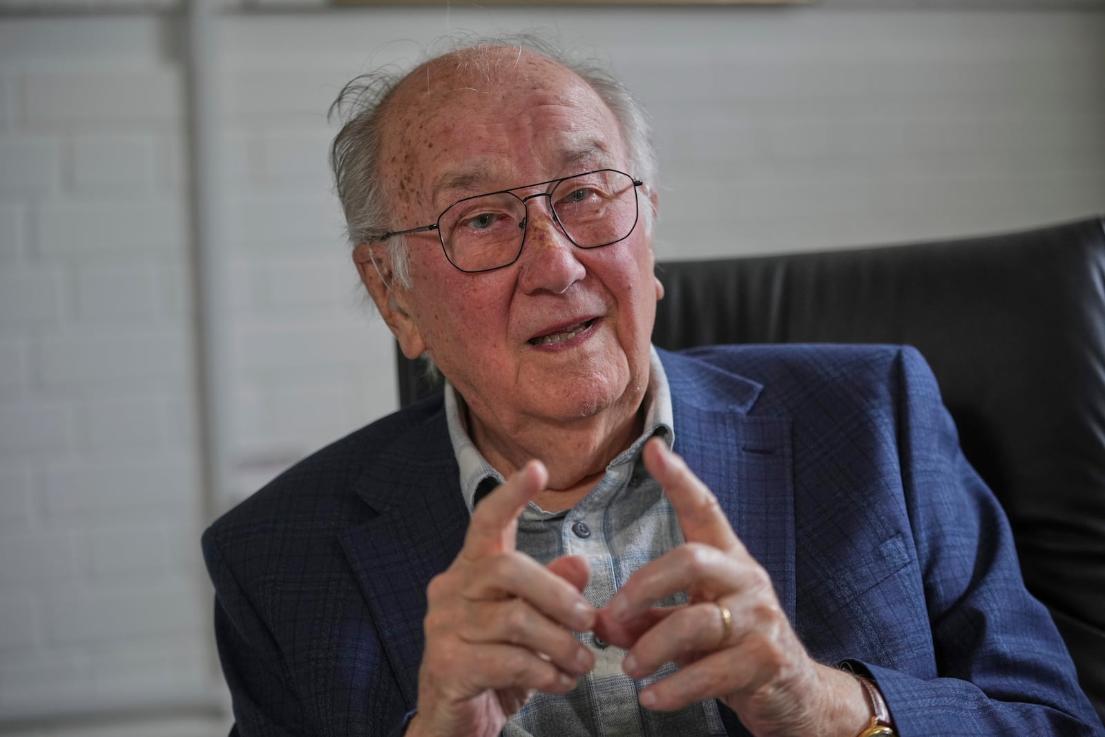 John Goldsmith, 94, gestures during an interview at his home in London, Thursday, April 24, 2025. (AP Photo/Kin Cheung)