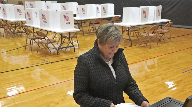 Mary Jane Wardley puts her ballot in the voting machine at Tecumseh High School Tuesday. BILL LACKEY/STAFF