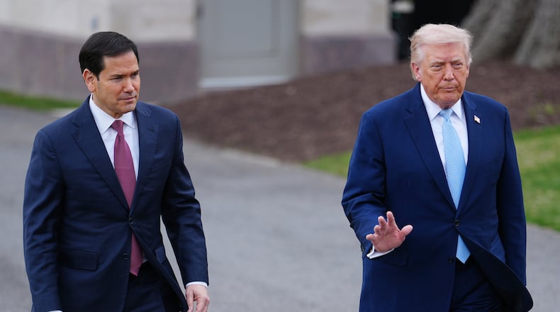 President Donald Trump walks with Secretary of State Marco Rubio to speak with reporters before departing on Marine One from the South Lawn of the White House, Friday, March 20, 2026, in Washington. (AP Photo/Julia Demaree Nikhinson)
