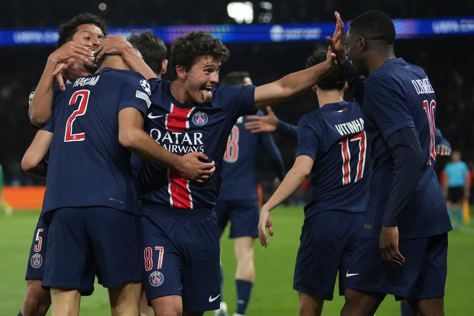 PSG's Achraf Hakimi, left, celebrates with teammates after scoring his sides second goal during the Champions League semifinal, second leg soccer match between Paris Saint-Germain and Arsenal at the Parc des Princes in Paris, Wednesday, May 7, 2025. (AP Photo/Thibault Camus)