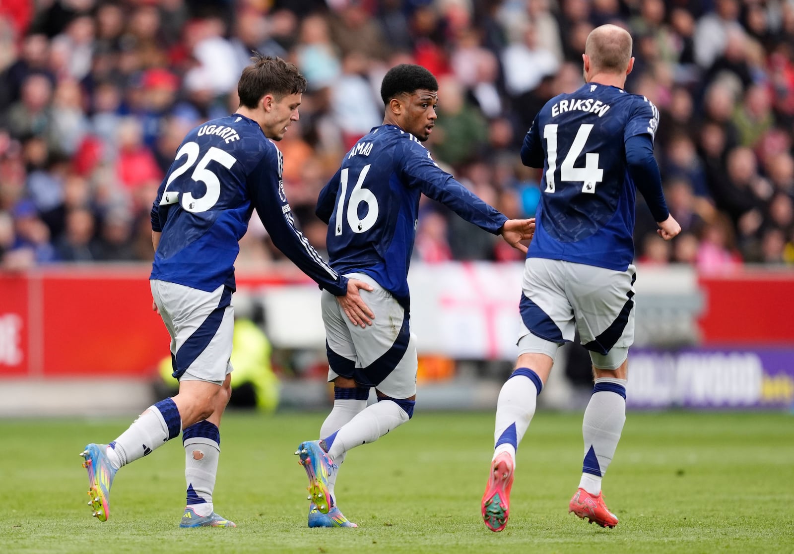 Manchester United's Amad Diallo, center, celebrates scoring their side's third goal of the game during the English Premier League soccer match between Brentford and Manchester United at the Gtech Community Stadium, London, Sunday, May 4, 2025. (John Walton/PA via AP)
