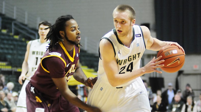 Wright State's guard Matt Vest (24) works past Loyola's guard Jeff White (23) on Monday evening Feb. 4, 2013 at the Wright State University Nutter Center Contributed Photo by Charles Caperton