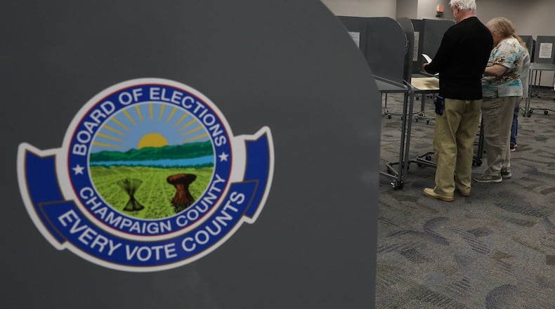 Voters fill out their ballots Tuesday at the Champaign County Government Center. BILL LACKEY/STAFF