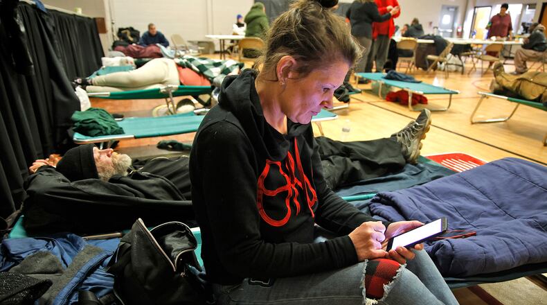 Melissa and her brother-in-law, Greg, relax on the cots in the gymnasium of the Springfield Salvation Army Tuesday, Jan. 16, 2024. The city of Springfield is partnering with the Nehemiah Foundation Faith Community Crisis Response Team, the Salvation Army, Sheltered Inc. and Homefull and has opened an Extreme Cold Weather Homeless Shelter to help those living on the street escape the bitter cold. BILL LACKEY/STAFF