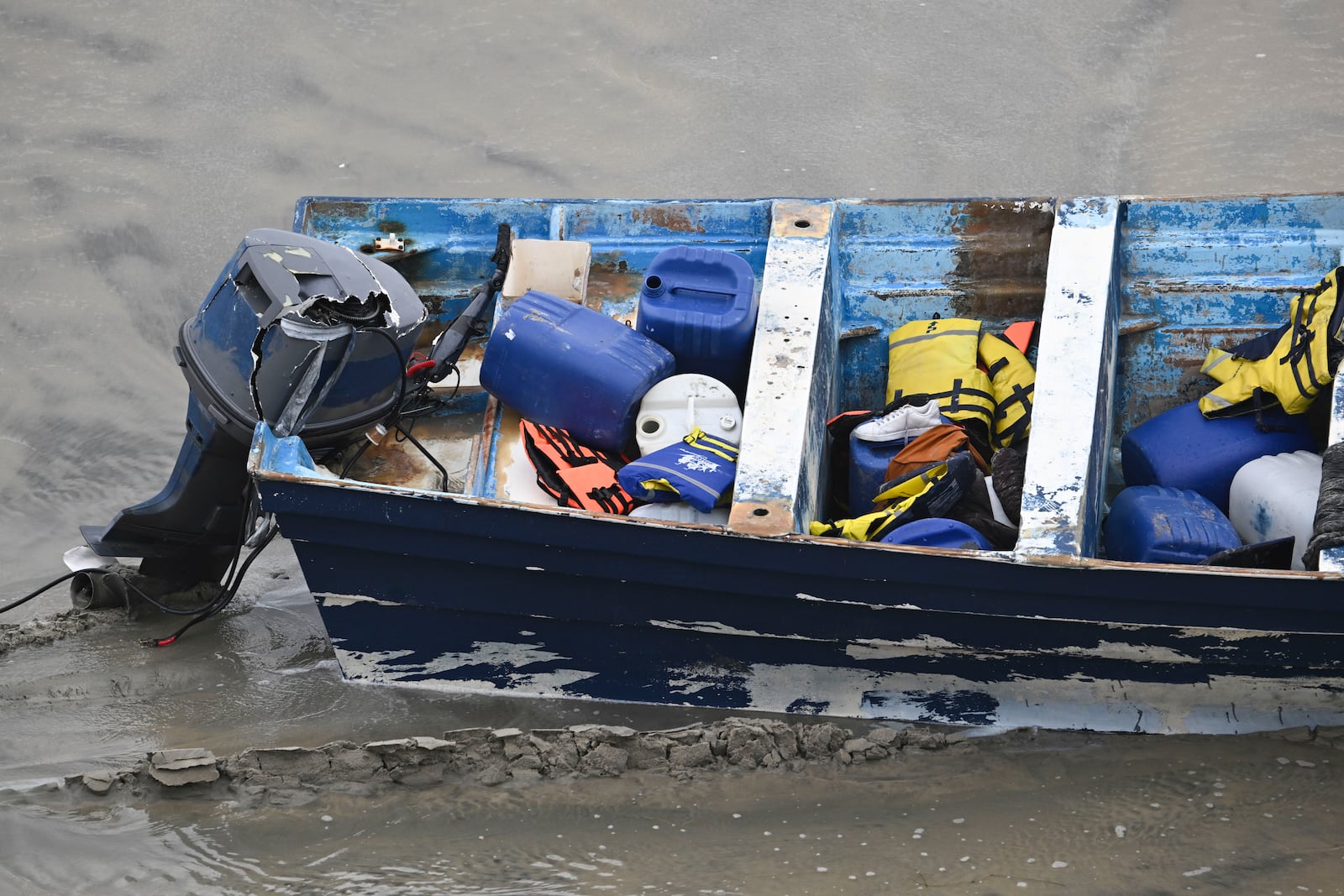 Life jackets and personal items are seen in a boat that capsized Friday, May. 5, 2025, in at Torrey Pines State beach in San Diego, Calif. (AP Photo/Denis Poroy)