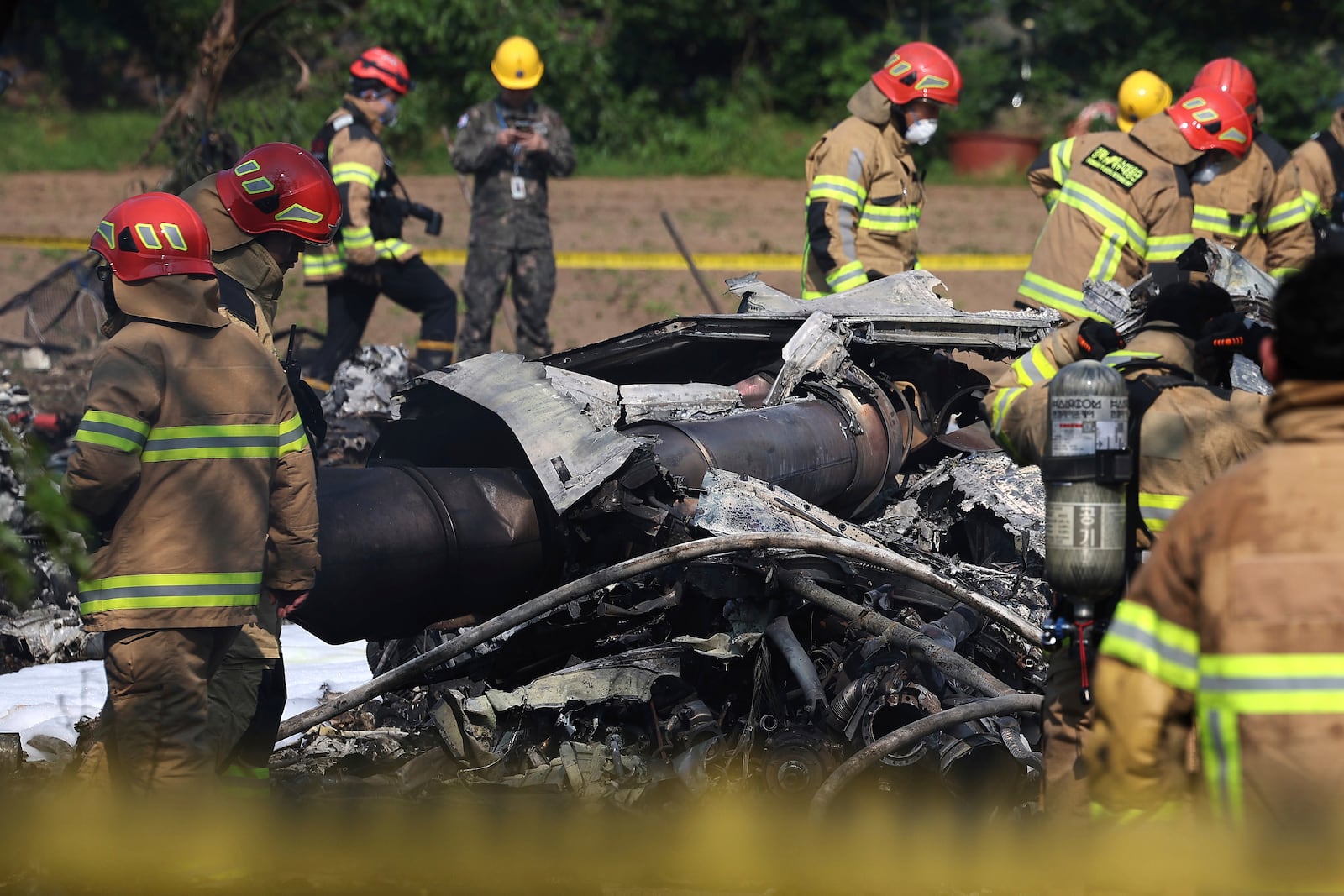 South Korean firefighters and military officers work at the scene of a South Korean navy plane's crash in Pohang, South Korea, Thursday, May 29, 2025. (Lee Mu-yeul/Newsis via AP)
