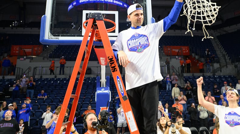Florida head coach Todd Golden holds the net after clinching the SEC regular season championship after an NCAA college basketball game against Arkansas, Saturday, Feb. 28, 2026, in Gainesville, Fla. (AP Photo/Noah Lantor)