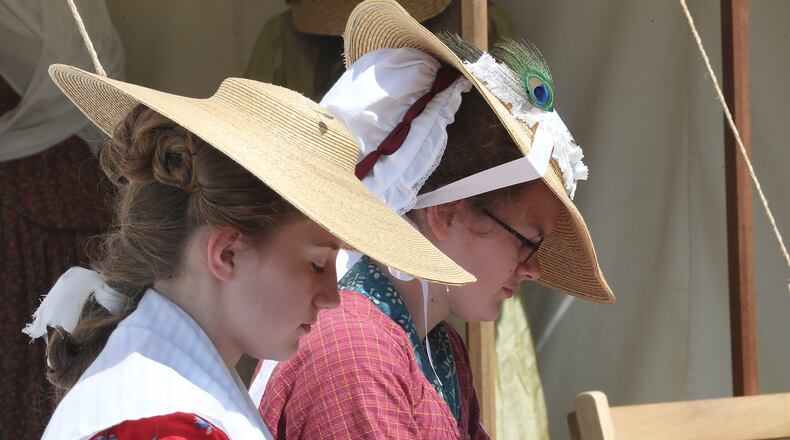 Ella and Sydney Dieterlen sewing in the sun at the Fair at New Boston Saturday. BILL LACKEY/STAFF