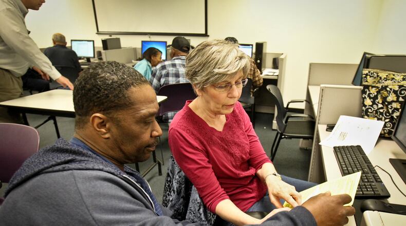 Volunteer Rachel Hurlbut helps Elvis Henderson with his tax preparation at the Montgomery County Job Center. Some in Ohio are working to get the Earned Income Tax Credit to more people as a means to both fight poverty and boost the economy. Policy Matters Ohio, left-leaning think tank, presented a proposal to the Ohio House Finance and Appropriations Committee last week to create a state-level EITC, as 24 other states have done. This is opposed by some, including the Buckeye Institute.