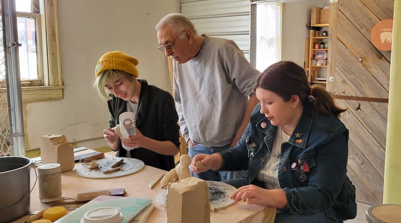 Maddie McCutcheon, right, and friend Robin Clingerman work with pottery expert Bruce Grimes preparing art they will sell at the Self-Love Art Showcase on Friday evening at the Hatch Artist Studios. Proceeds raised will go to Project Woman. Contributed photo