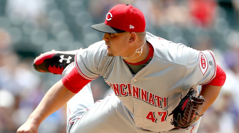 Reds starting pitcher Sal Romano throws in the fifth inning against the Rockies at Coors Field Thursday on the way to picking up his first career MLB win.
