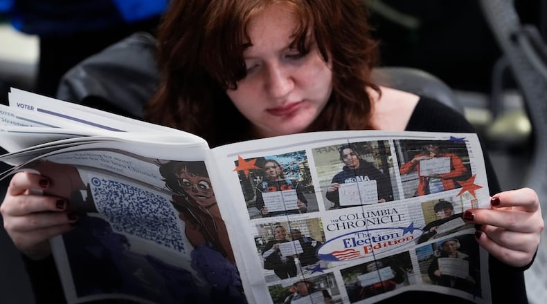 FILE - Columbia College Chicago student Kailey Ryan reads a newspaper in Chicago on Nov. 5, 2024. (AP Photo/Nam Y. Huh, File)