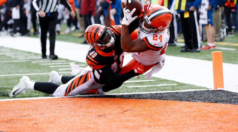CINCINNATI, OH - NOVEMBER 25: Nick Chubb #24 of the Cleveland Browns catches a pass for a touchdown over the defense of Brandon Wilson #40 of the Cincinnati Bengals during the second quarter at Paul Brown Stadium on November 25, 2018 in Cincinnati, Ohio. (Photo by Joe Robbins/Getty Images)