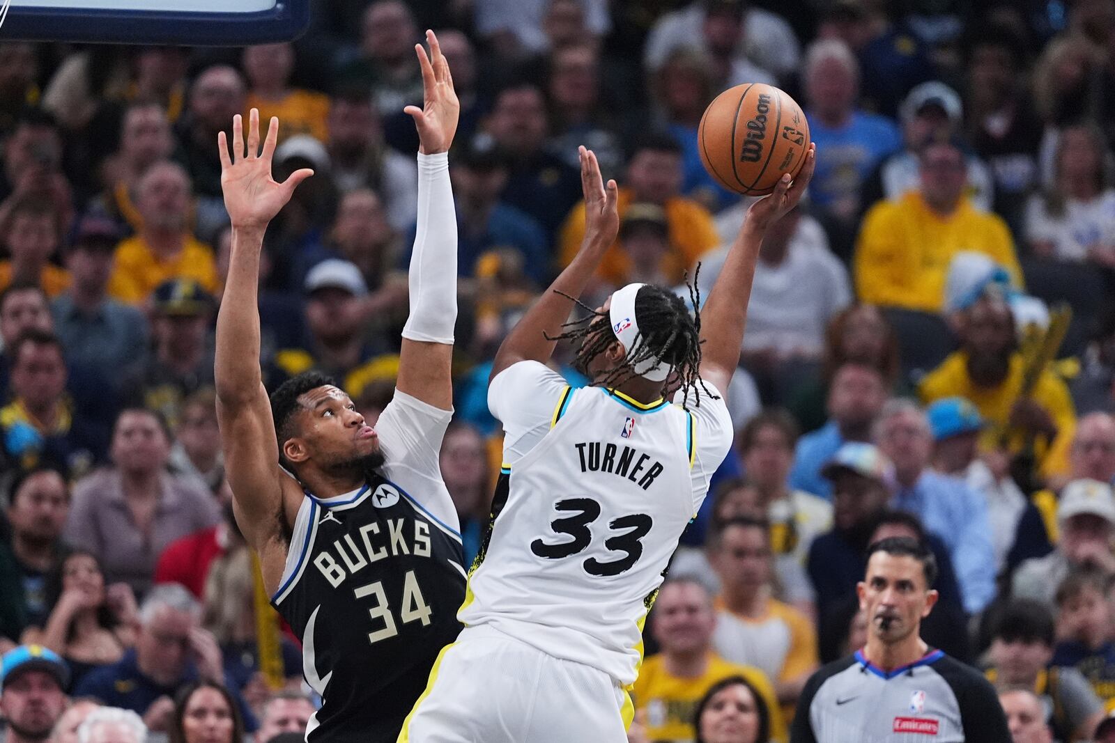 Indiana Pacers center Myles Turner (33) shoots over Milwaukee Bucks forward Giannis Antetokounmpo (34) during the first half of a first-round NBA basketball playoff game in Indianapolis, Tuesday, April 22, 2025. (AP Photo/Michael Conroy)