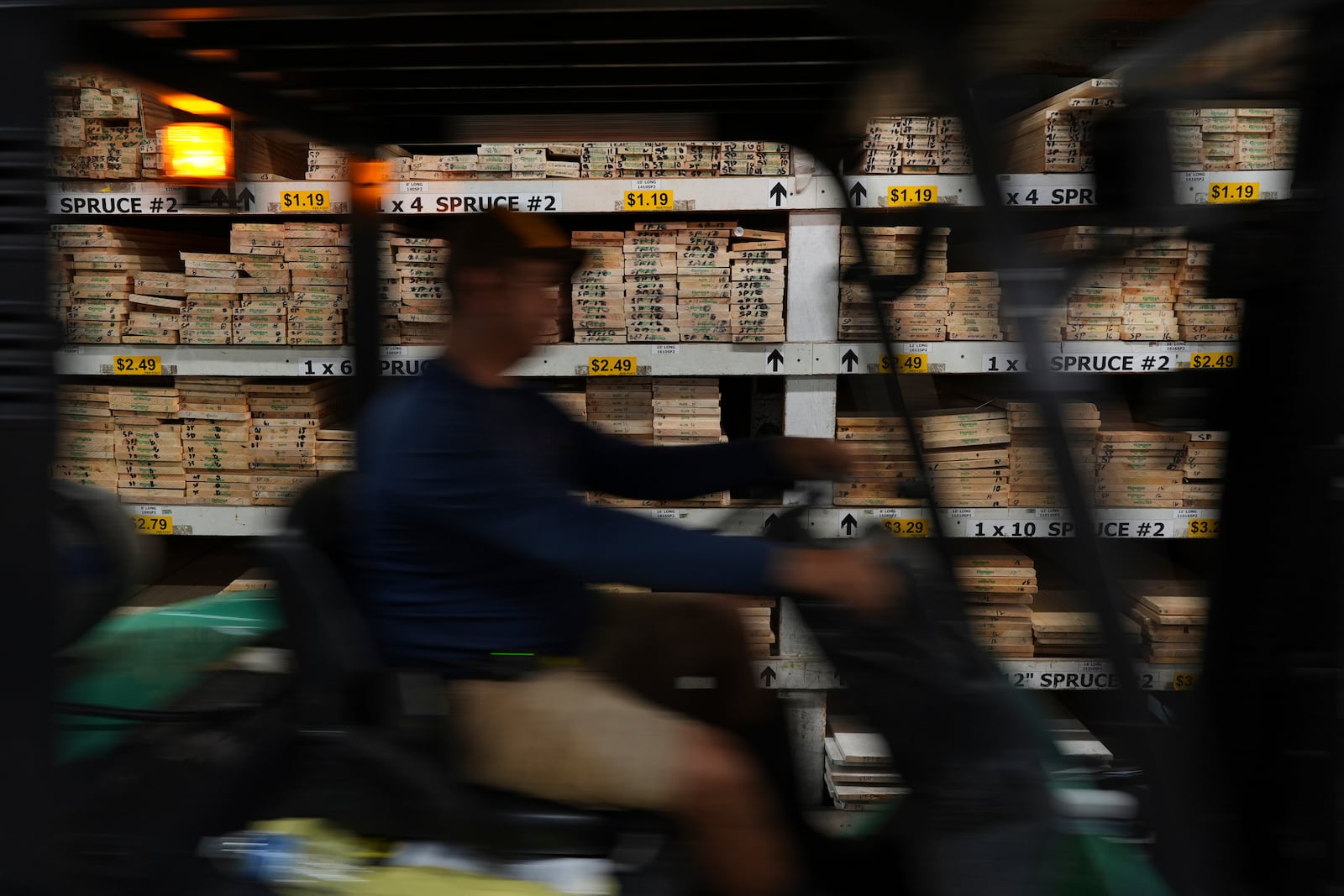 FILE - A worker drives a forklift past shelves of Canadian spruce planks, at Shell Lumber and Hardware, Tuesday, April 8, 2025, in Miami. (AP Photo/Rebecca Blackwell, File)