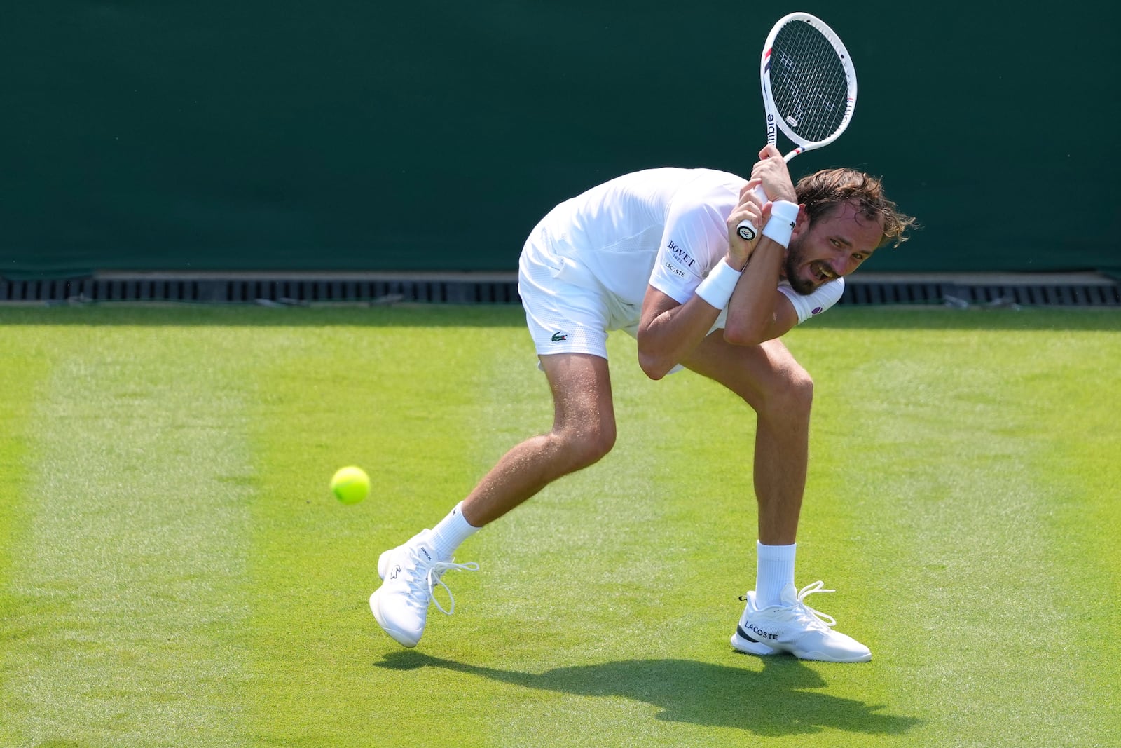 Daniil Medvedev of Russia returns the ball to Benjamin Bonzi of France during their first round men's single match at the Wimbledon Tennis Championships in London, Monday, June 30, 2025. (AP Photo/Kirsty Wigglesworth)