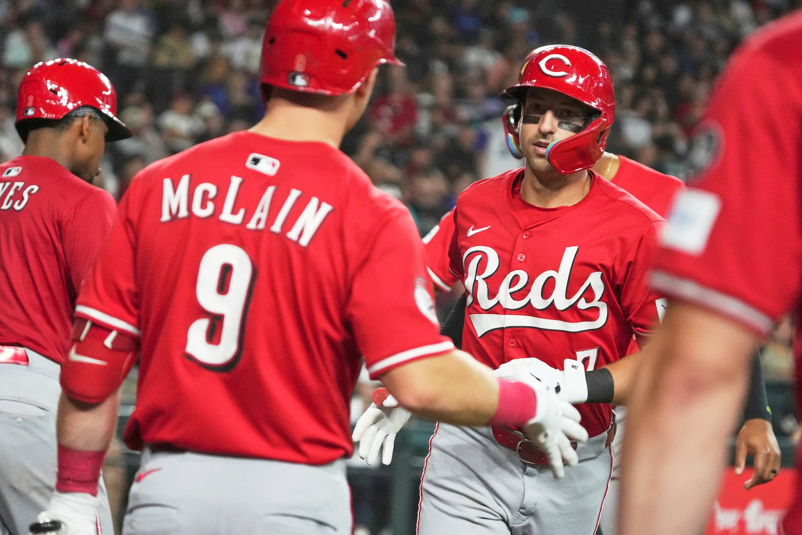Cincinnati Reds' Spencer Steer celebrates with teammates after hitting a three-run home run against the Arizona Diamondbacks in the eighth inning of a baseball game Sunday, Aug 24, 2025, in Phoenix. (AP Photo/Rick Scuteri)