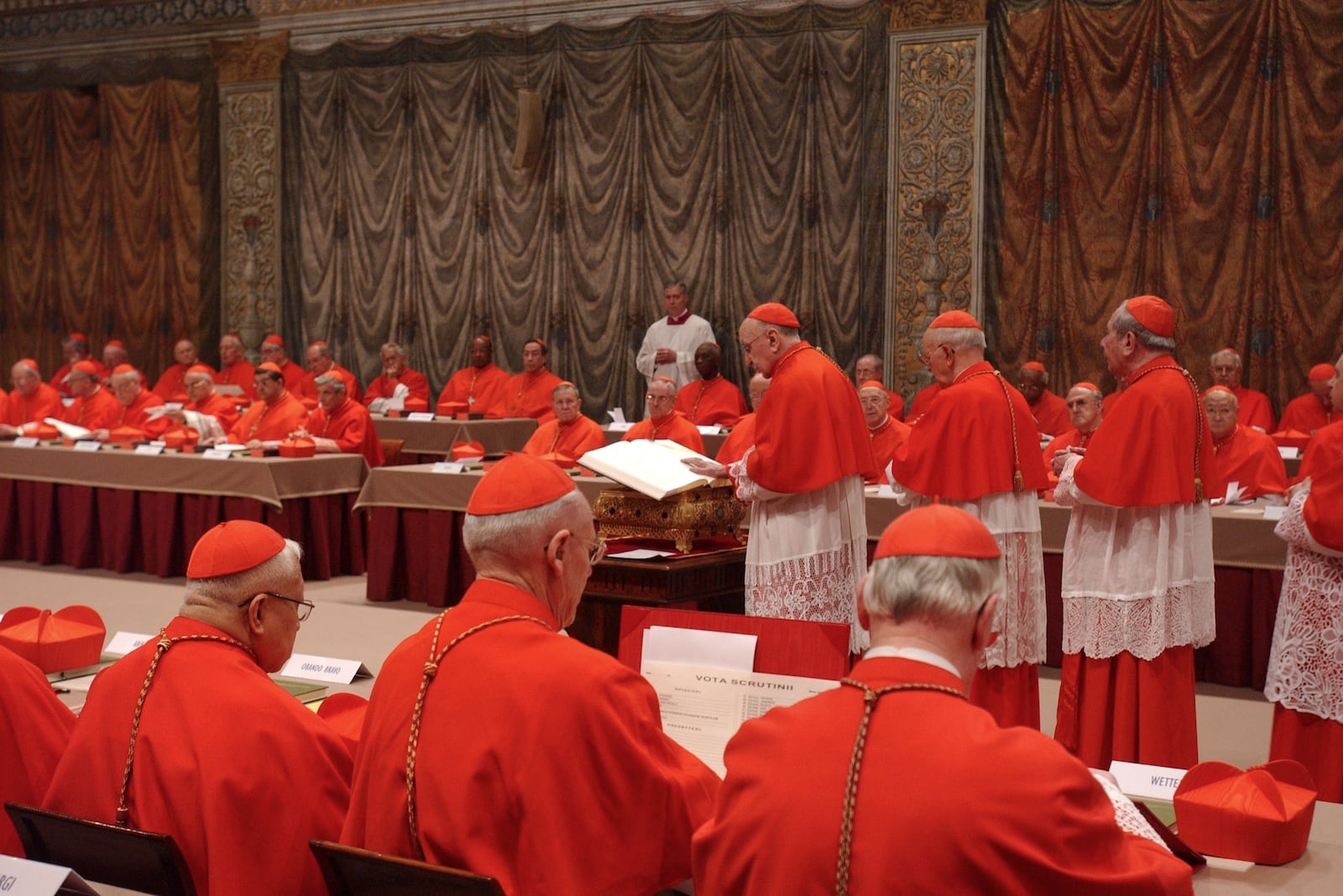 FILE - Italian Cardinal Giacomo Biffi, center, takes an oath at the beginning of the conclave to elect the next pope in the Sistine Chapel at the Vatican, Monday, April 18, 2005. (AP Photo/Osservatore Romano via AP, File)