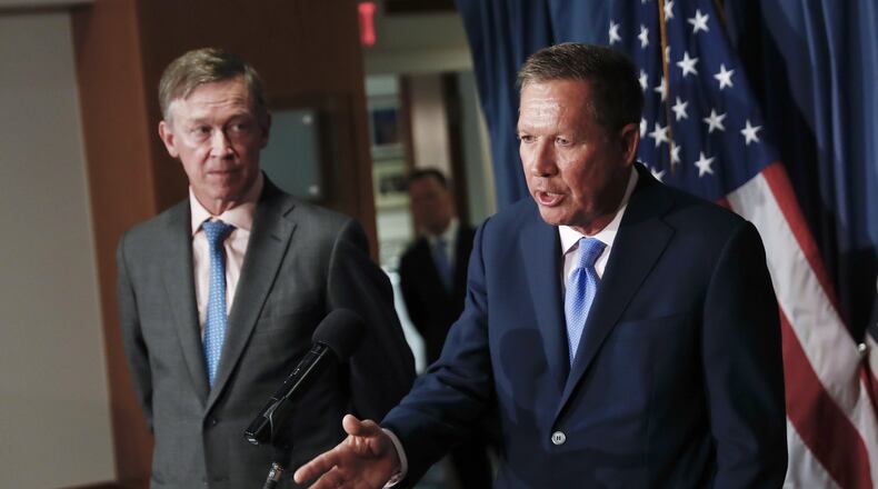 In this June 27, 2017, file photo, Ohio Gov. John Kasich, right, is joined by Colorado Gov. John Hickenlooper during a news conference at the National Press Club in Washington. The bipartisan governor duo is urging Congress to retain the federal health care law’s unpopular individual mandate while seeking to stabilize individual insurance markets. (AP Photo/Carolyn Kaster, file)