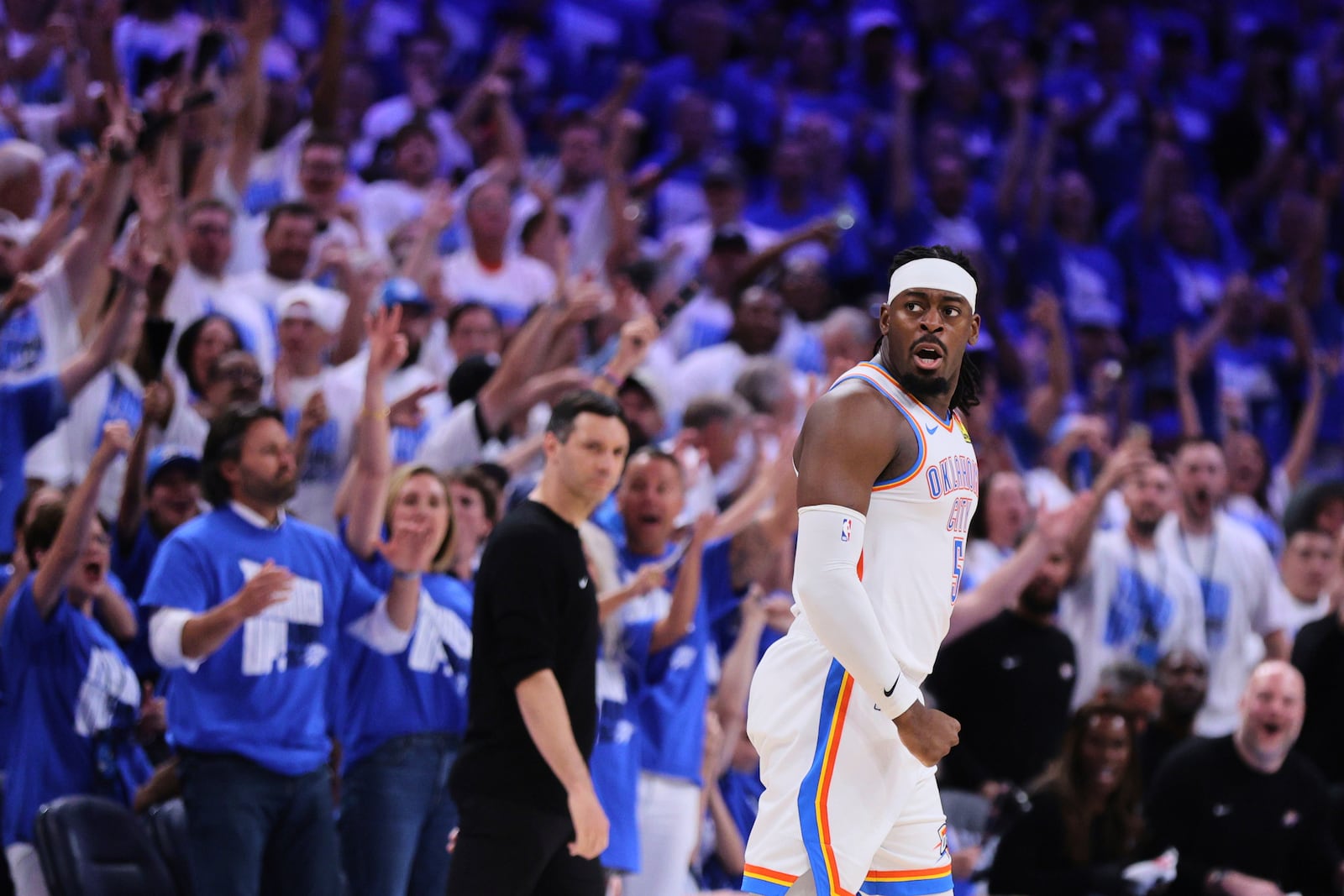 Fans cheer as Oklahoma City Thunder's Luguentz Dort celebrates sinking a three-pointer in the second half of Game 5 of an NBA basketball second-round playoff series against the Denver Nuggets Tuesday, May 13, 2025, in Oklahoma City. (AP Photo/Nate Billings)