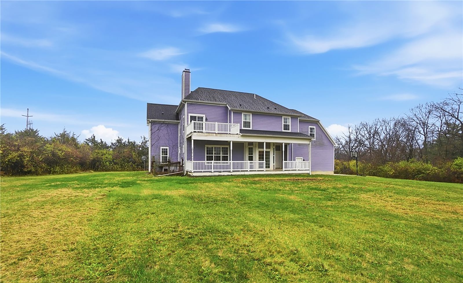 The back of the home has a covered porch that extends across most of the back, a second story private balcony and solar panels (in the yard). CONTRIBUTED
