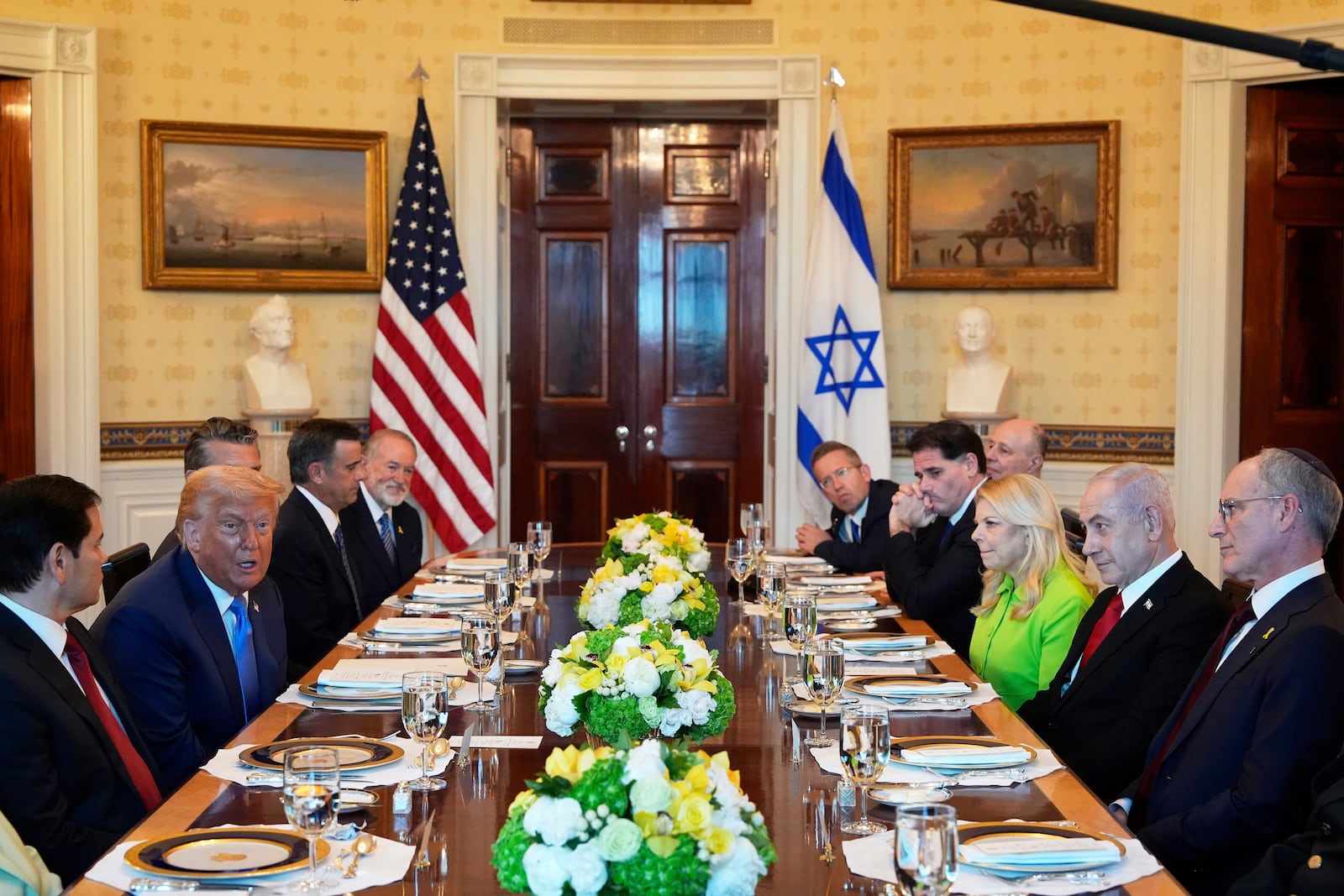 President Donald Trump, second from left, meets with Israel's Prime Minister Benjamin Netanyahu, second from right, as Secretary of State Marco Rubio, from left, Defense Secretary Pete Hegseth, obstructed, CIA Director John Ratcliffe, U.S. Ambassador to Israel Mike Huckabee, and from right, Israeli Ambassador to the U.S. Yechiel Leiter, Netanyahu's wife Sara Netanyahu, Israel's Strategic Affairs Minister Ron Dermer, Israel's National Security Council head Tzachi Hanegbi and Israel's Cabinet Secretary Yossi Fuchs listen in the Blue Room of the White House, Monday, July 7, 2025, in Washington. (AP Photo/Alex Brandon)
