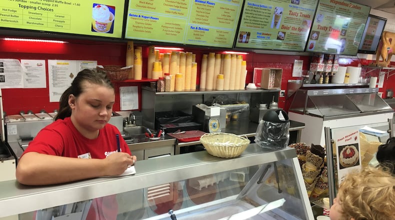 Emily Dyer of Springfield takes a customer order at Young’s Jersey Dairy. KARA DRISCOLL/STAFF