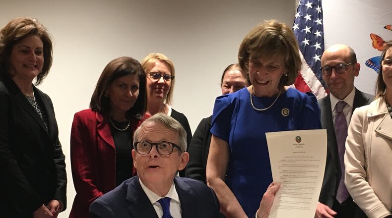 Gov. Mike DeWine signs an executive order to set up a panel of experts on how to improve Ohio’s home visit program for at-risk pregnant women, new moms and their babies. Photo by Laura Bischoff