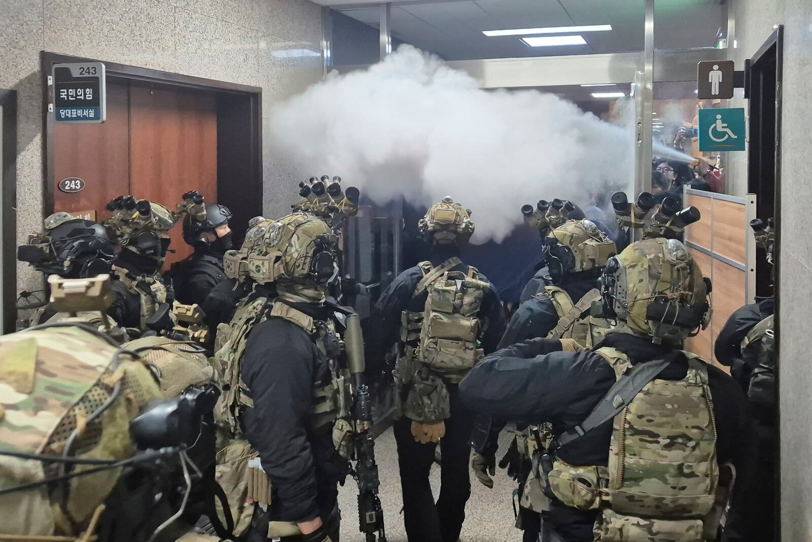 FILE - National Assembly employees spray a fire extinguisher towards soldiers at the National Assembly in Seoul, South Korea, Wednesday, Dec. 4, 2024. (Cho Da-un/Yonhap via AP, File)