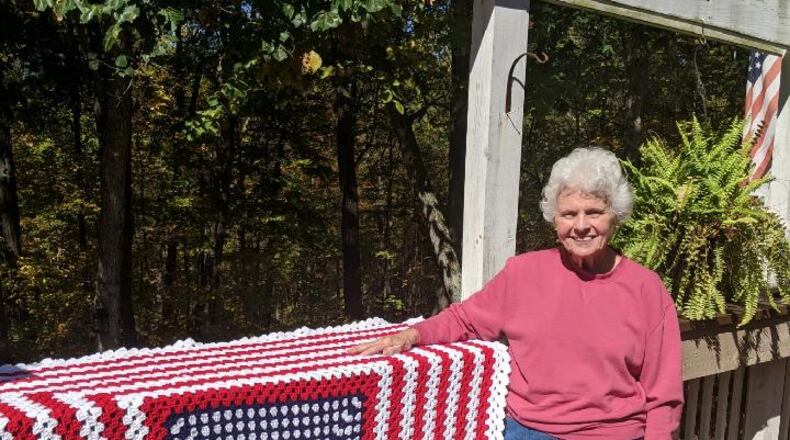 Breast cancer survivor Janet "Jan" Clements of Springdale with one of the afghans she made for the veterans. CONTRIBUTED