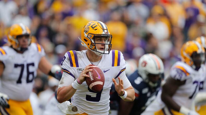 FILE - In this Oct. 26, 2019, file photo, LSU quarterback Joe Burrow (9) scrambles during the first half of the team's NCAA college football game against Auburn in Baton Rouge, La. Burrow was selected first in the 2020 NFL Draft by the Cincinnati Bengals and was among three 2017 Ohio State Buckeyes teammates picked in the top five.