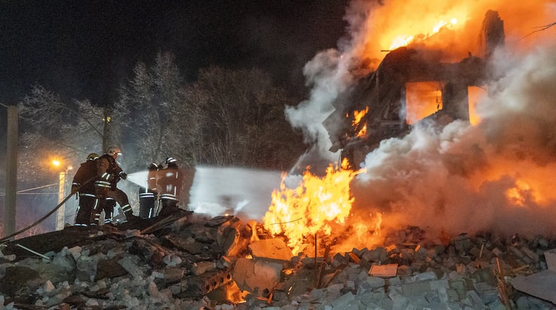 Firefighters put out the fire in an multi-storey apartment building following a Russian missile attack in Kharkiv, Ukraine, Saturday, March 7, 2026. (AP Photo/Andrii Marienko)