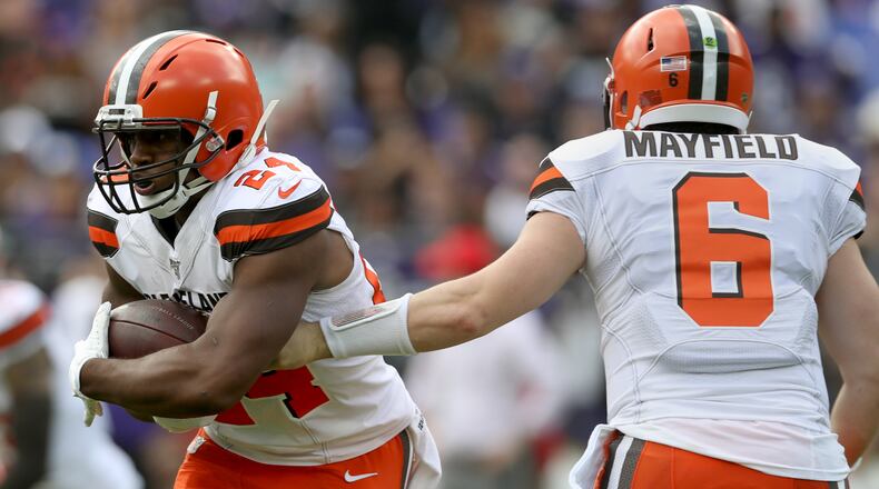 BALTIMORE, MARYLAND - SEPTEMBER 29: Quarterback Baker Mayfield #6 of the Cleveland Browns hands offsides to running back Nick Chubb #24 during the first quarter of the game against the Baltimore Ravens at M&T Bank Stadium on September 29, 2019 in Baltimore, Maryland. (Photo by Rob Carr/Getty Images)