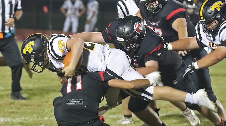 Shawnee's Tyler Mercer dives over Tecumseh's Jackson Berner. BILL LACKEY/STAFF