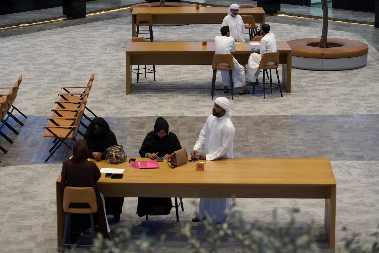 Emiratis are seen in the Dubai Financial Market in Dubai, United Arab Emirates, Monday, April 7, 2025. (AP Photos/Fatima Shbair)