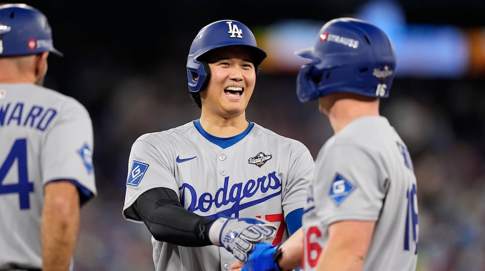 Los Angeles Dodgers' Shohei Ohtani and Will Smith talk during the eighth inning in Game 6 of baseball's World Series against the Toronto Blue Jays, Friday, Oct. 31, 2025, in Toronto. (AP Photo/Brynn Anderson)