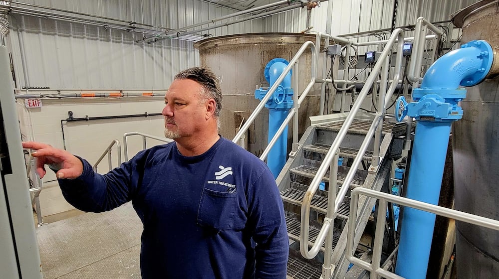Yellow Springs Utility Operator Jeff Horn at work at the Yellow Springs village water filtration plant, Feb. 6, 2026. The tanks in the background are used to filter water through a combination of quartz sand and a chemical base to pull calcium and other particles out of residents' drinking water. LONDON BISHOP/STAFF
