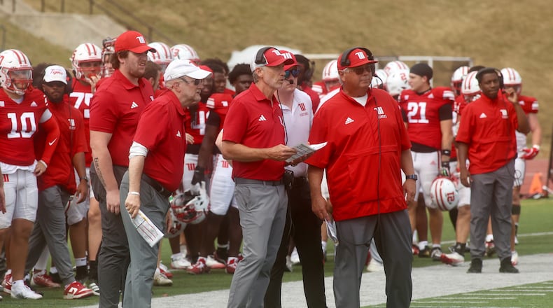 Wittenberg's Jim Collins huddles with assistants during a game against Washington and Lee on Saturday, Sept. 13, 2025, at Edwards-Maurer Field in Springfield. David Jablonski/Staff