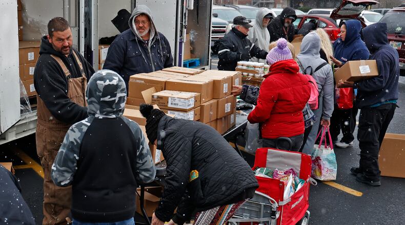 Volunteers pass out food at Second Harvest Food Bank's Mobile Pantry Wednesday, Nov. 16, 2022 in the parking lot of the First United Church of Christ in Springfield. BILL LACKEY/STAFF