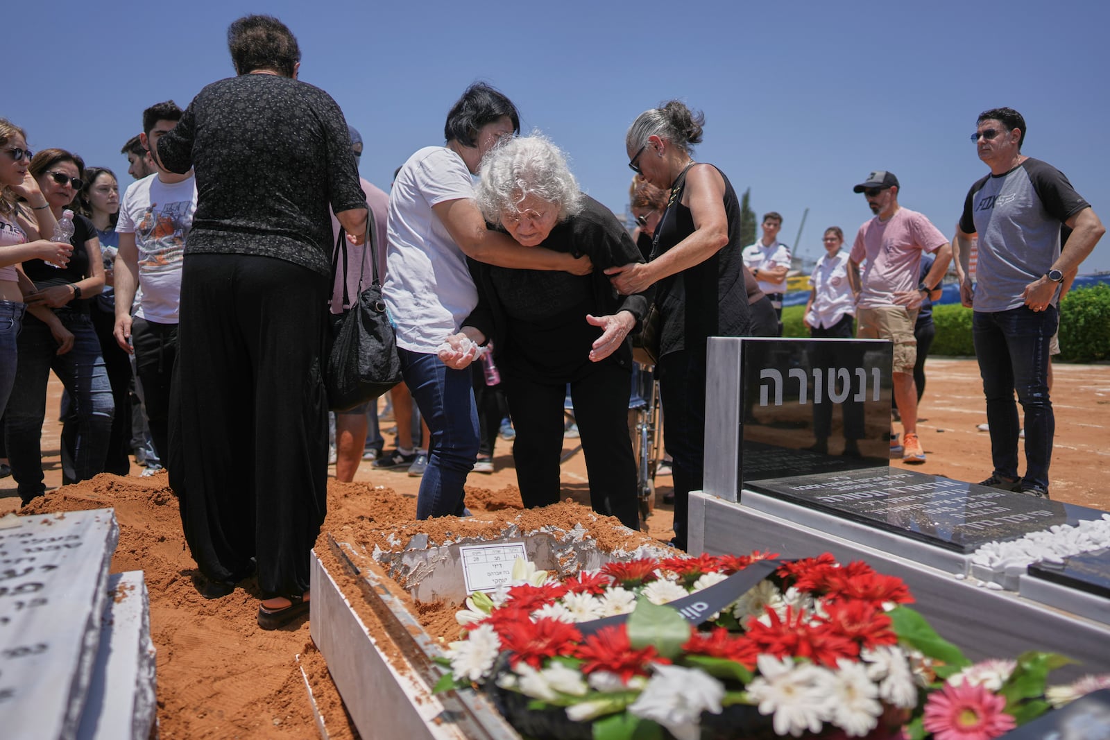 Relatives and friends of Daisy Yitzhaki, 85, who was killed during an Iranian missile attack, mourn during her funeral at Segula cemetery in Petah Tikva, Israel, Wednesday, June 18, 2025. (AP Photo/Oded Balilty)
