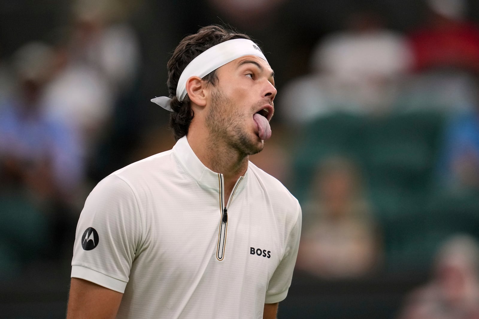 Taylor Fritz of the U.S. reacts during his first round men's single match against Giovanni Mpetshi Perricard of France at the Wimbledon Tennis Championships in London, Monday, June 30, 2025. (AP Photo/Kin Cheung)