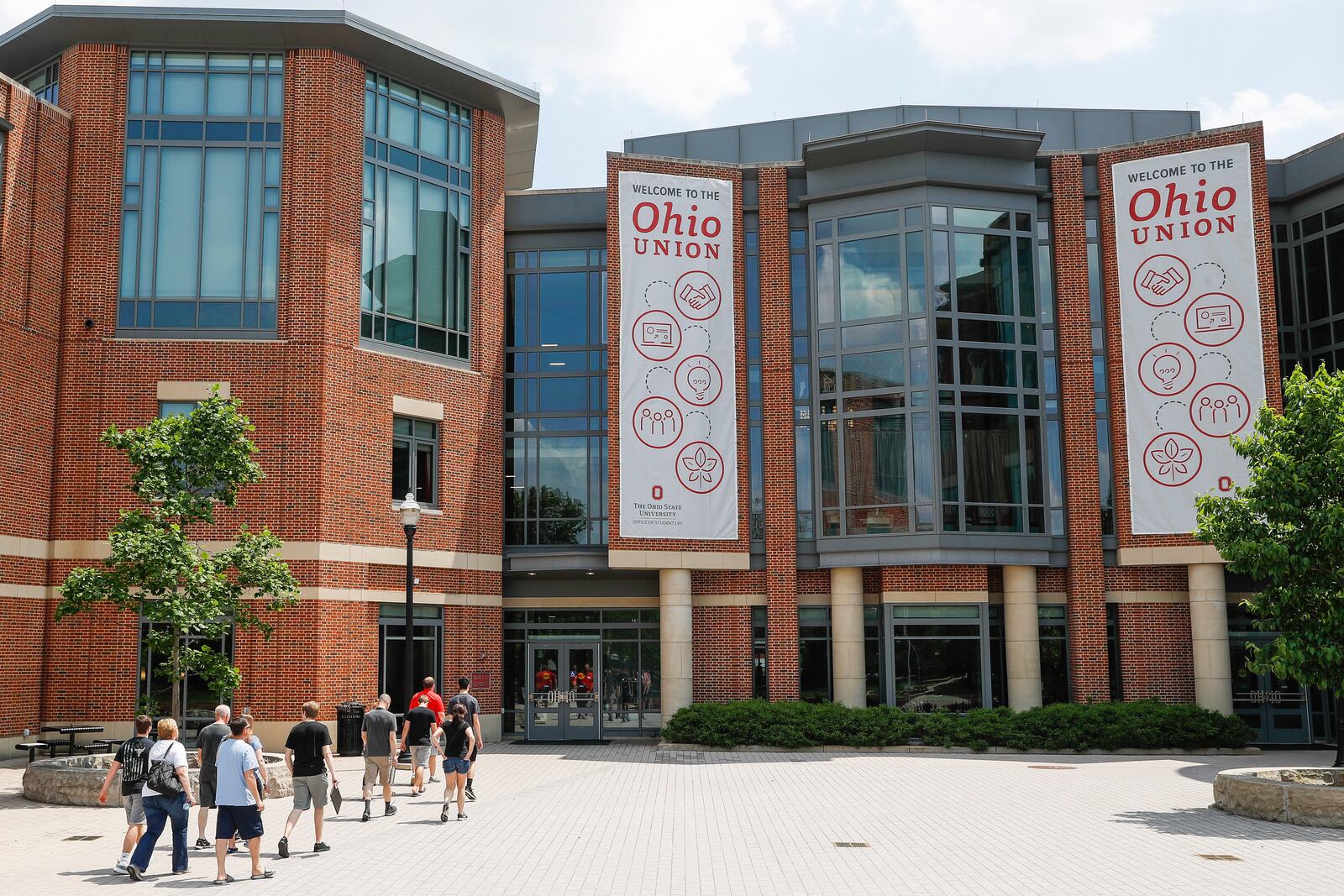 FILE -Pedestrians walk up to the The Ohio State University's student union, Saturday, May 18, 2019, in Columbus, Ohio. (AP Photo/John Minchillo, File)