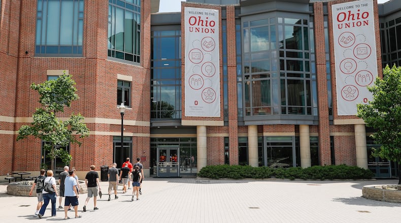 FILE -Pedestrians walk up to the The Ohio State University's student union, Saturday, May 18, 2019, in Columbus. (AP Photo/John Minchillo, File)