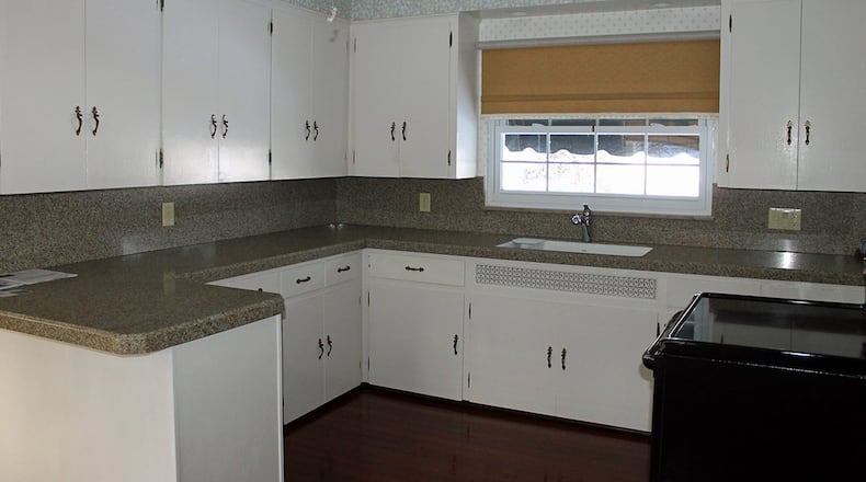 The kitchen offers a U-shaped work area and an abundance of counter space.